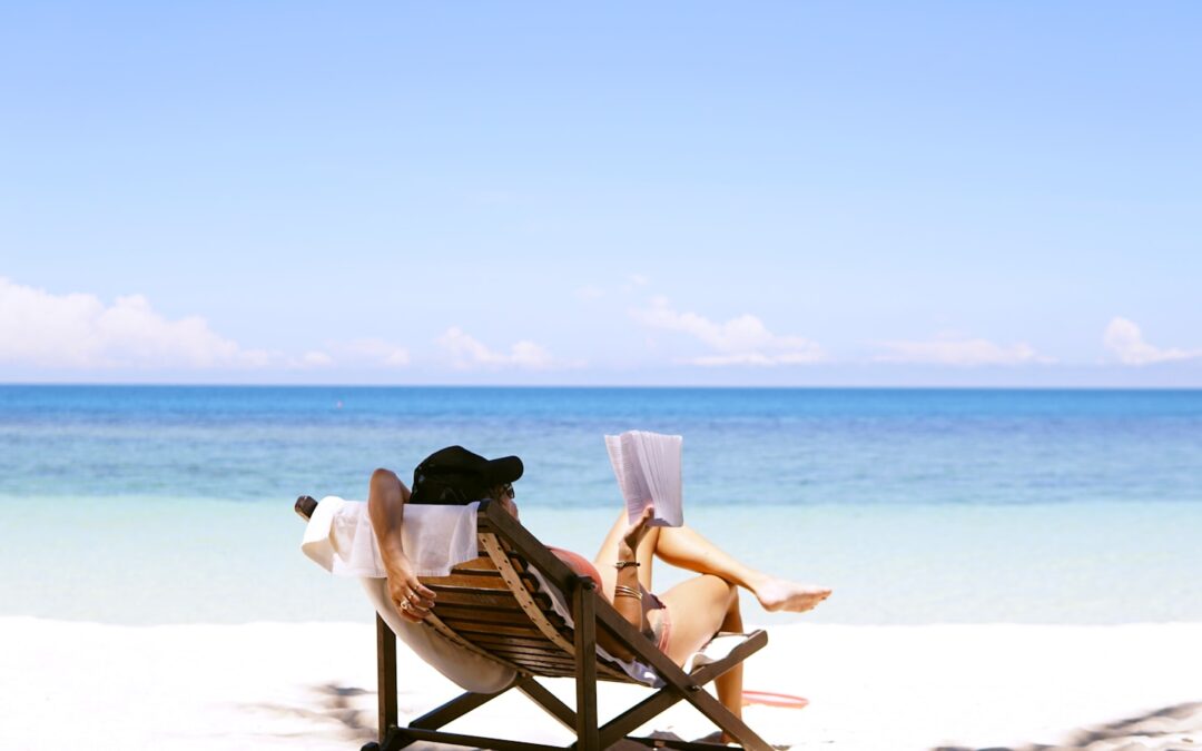 woman sits on brown wooden beach chair