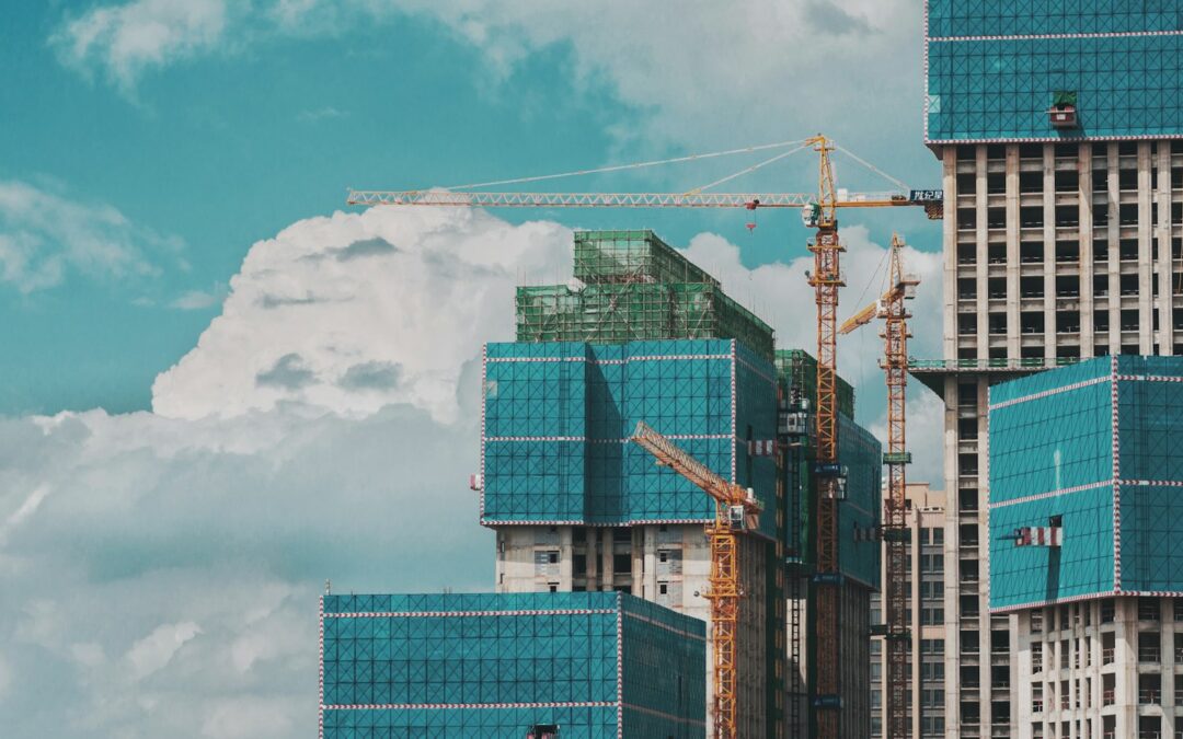 a group of tall buildings under a cloudy blue sky